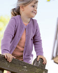 Lifestyle photo of the kids Disana honeycomb cardigan in lilac