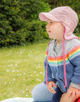 Child wearing Pickapooh organic cotton hat in soft pink