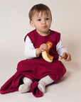 Lifestyle photo of child wearing Reiff wool/silk sleepsack in berry