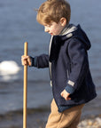 Child wearing the Disana boiled wool Outdoor Jacket in navy