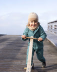 Lifestyle photo of Disana boiled wool overall in Eucalyptus
