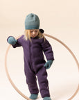 Lifestyle photo of girl in Disana boiled organic merino wool mittens in eucalytpus