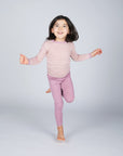 Girl in Engel children's 100% organic wool leggings in rose heather