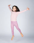 Girl in Engel children's 100% organic wool leggings in rose heather