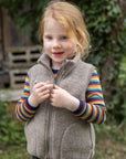 Girl in Engel kids' organic wool fleece vest in walnut