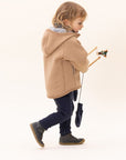 Lifestyle photo of girl in Disana boiled organic merino wool mittens in indigo