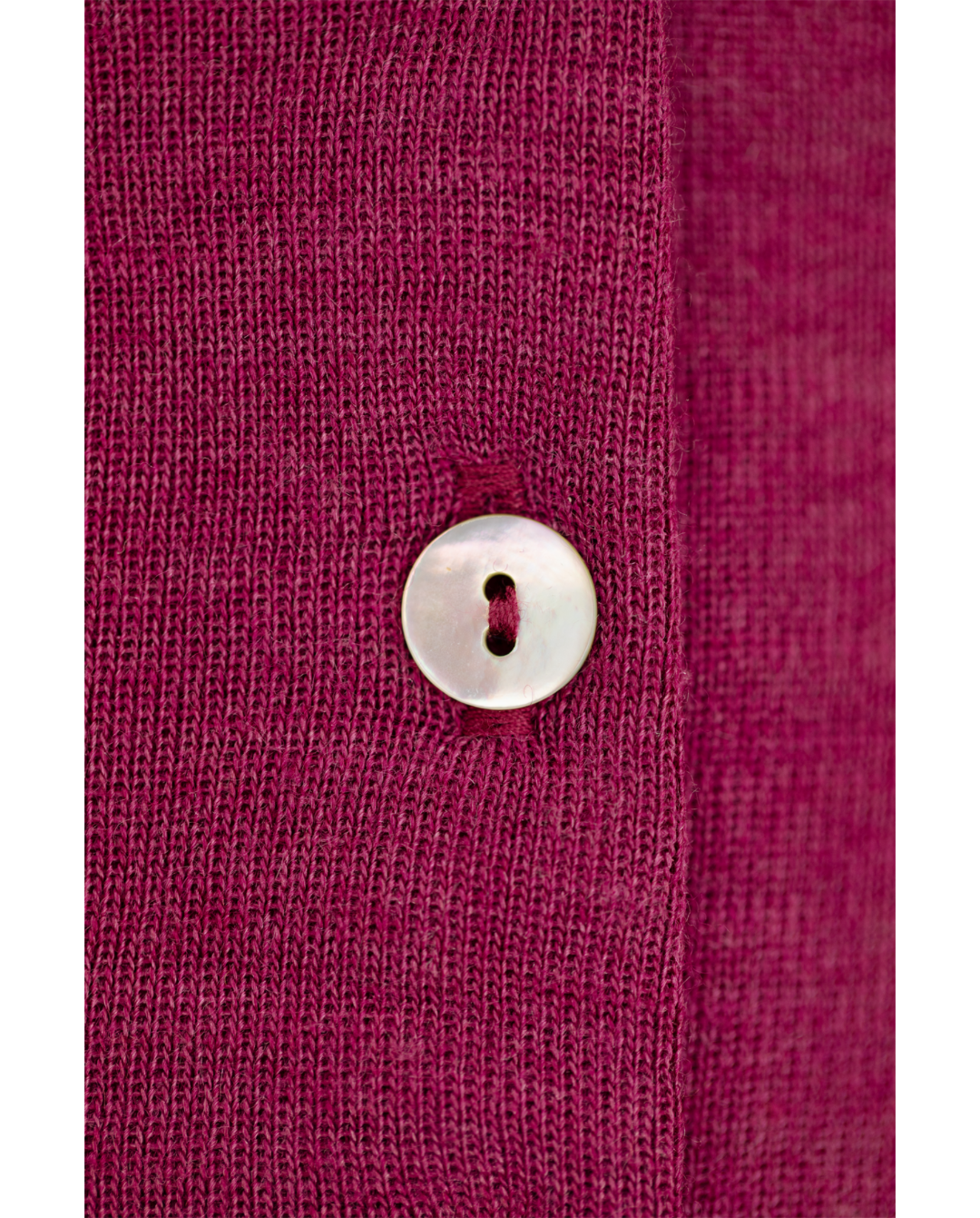 Button detail of the Engel wool-silk baby cardigan in orchid