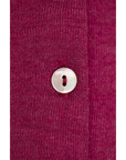Button detail of the Engel wool-silk baby cardigan in orchid