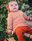Lifestyle photo of Engel baby stripe wool/silk shirt in tangerine