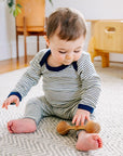 Lifestyle photo of Engel wool-silk bodysuit in navy-natural stripe.