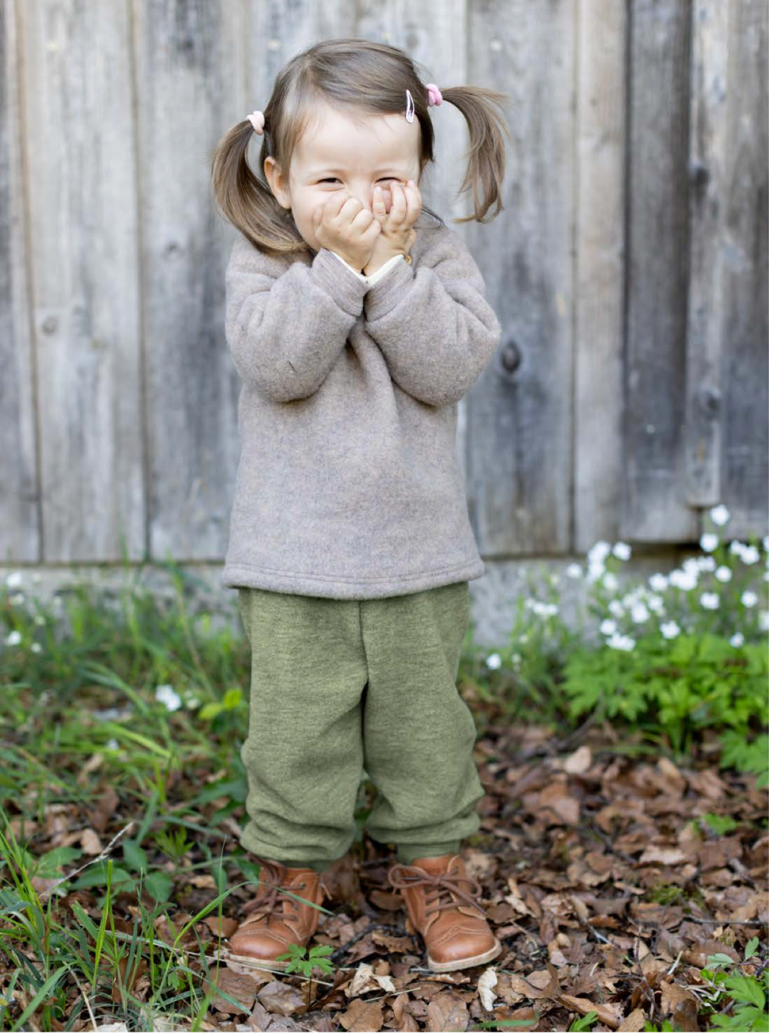 Lifestyle photo of toddler in walnut wool fleece pullover by Engel