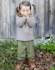 Lifestyle photo of toddler in walnut wool fleece pullover by Engel