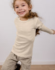 Girl in Engel 100% wool kids shirt in natural
