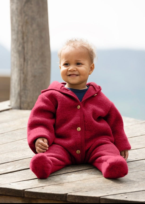 Lifestyle photo of baby in the Engel wool fleece hooded baby bunting