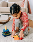 child playing in red-natural striped wool shirt by Engel