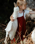 Young girl holding the Senger Cuddly large white goose made of organic cotton non-toxic materials