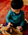 Toddler wearing Disana wool melange side button sweater in pacific-lagoon