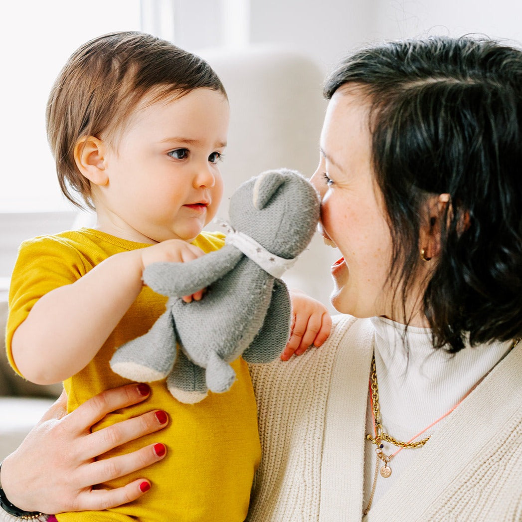 Lifestyle photo of baby in Engel wool-silk tee in saffron