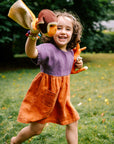 Lifestyle photo of the Bigelow Lane linen summer dress, in two-tone purple and clay