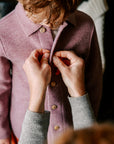 Mother dressing child in Engel boiled wool shacket in rose melange