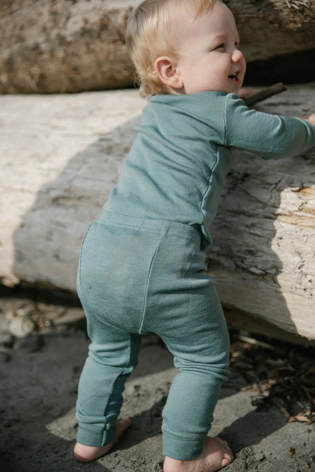 Baby in Simply Merino wool pajamas in willow blue