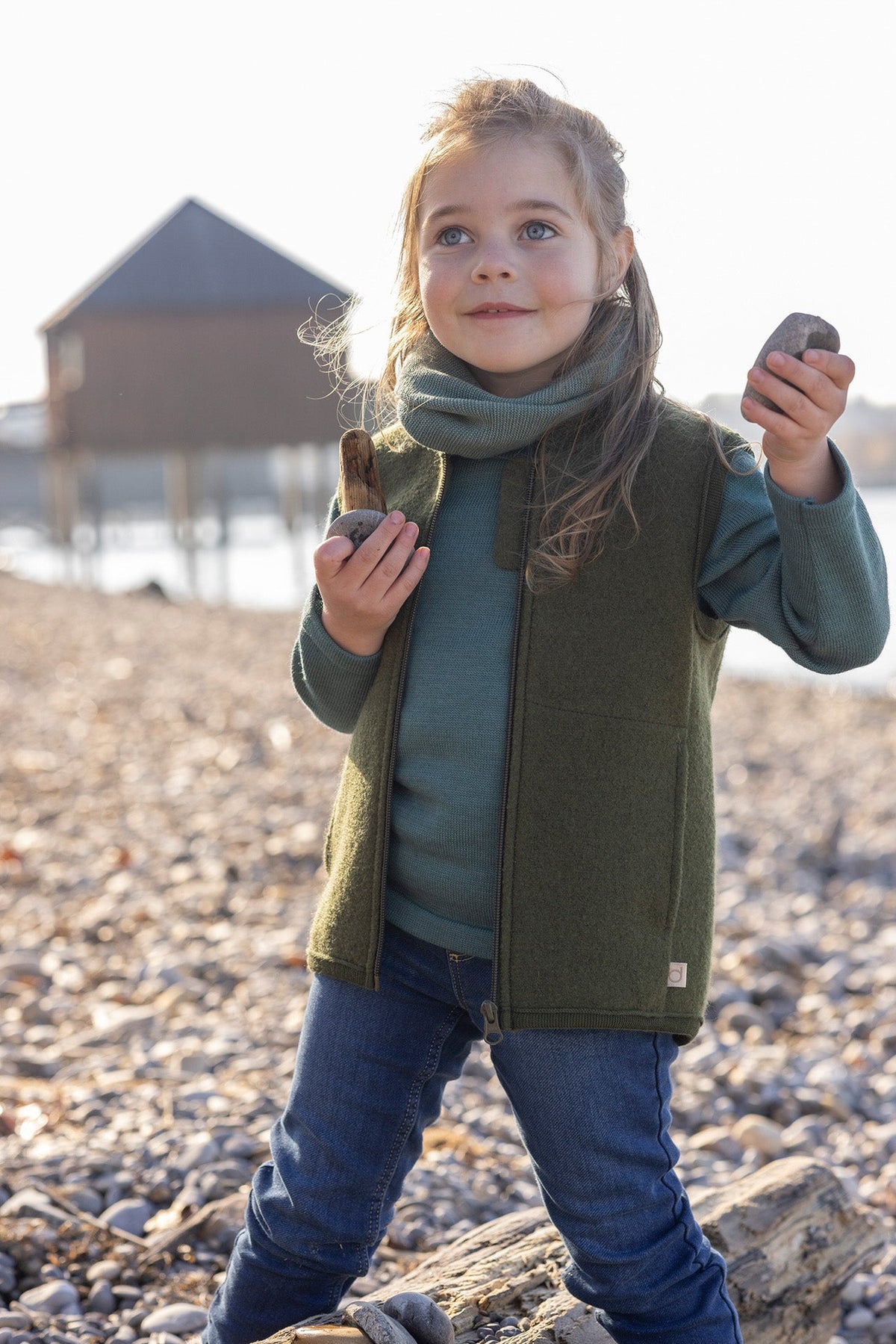Lifestyle photo of girl in boiled wool vest by Disana