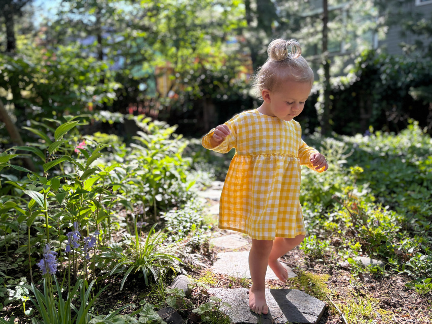little girl in yellow gingham long-sleeved linen dress