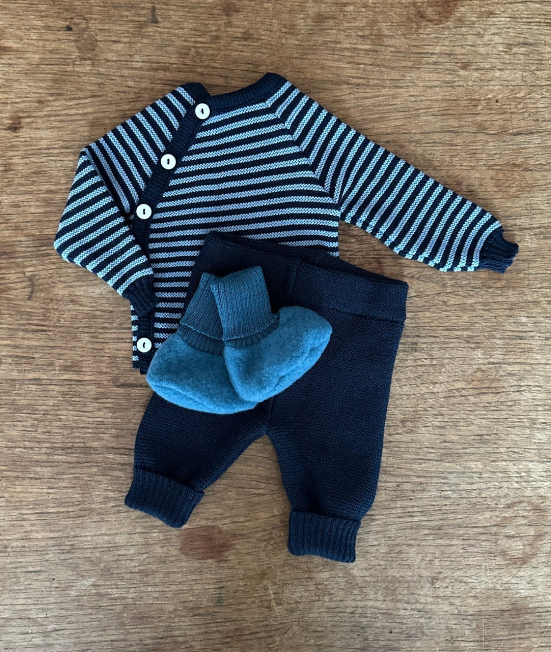 Reiff striped cardigan in navy and light blue, navy wool pants and ocean blue wool fleece booties. All made by Reiff