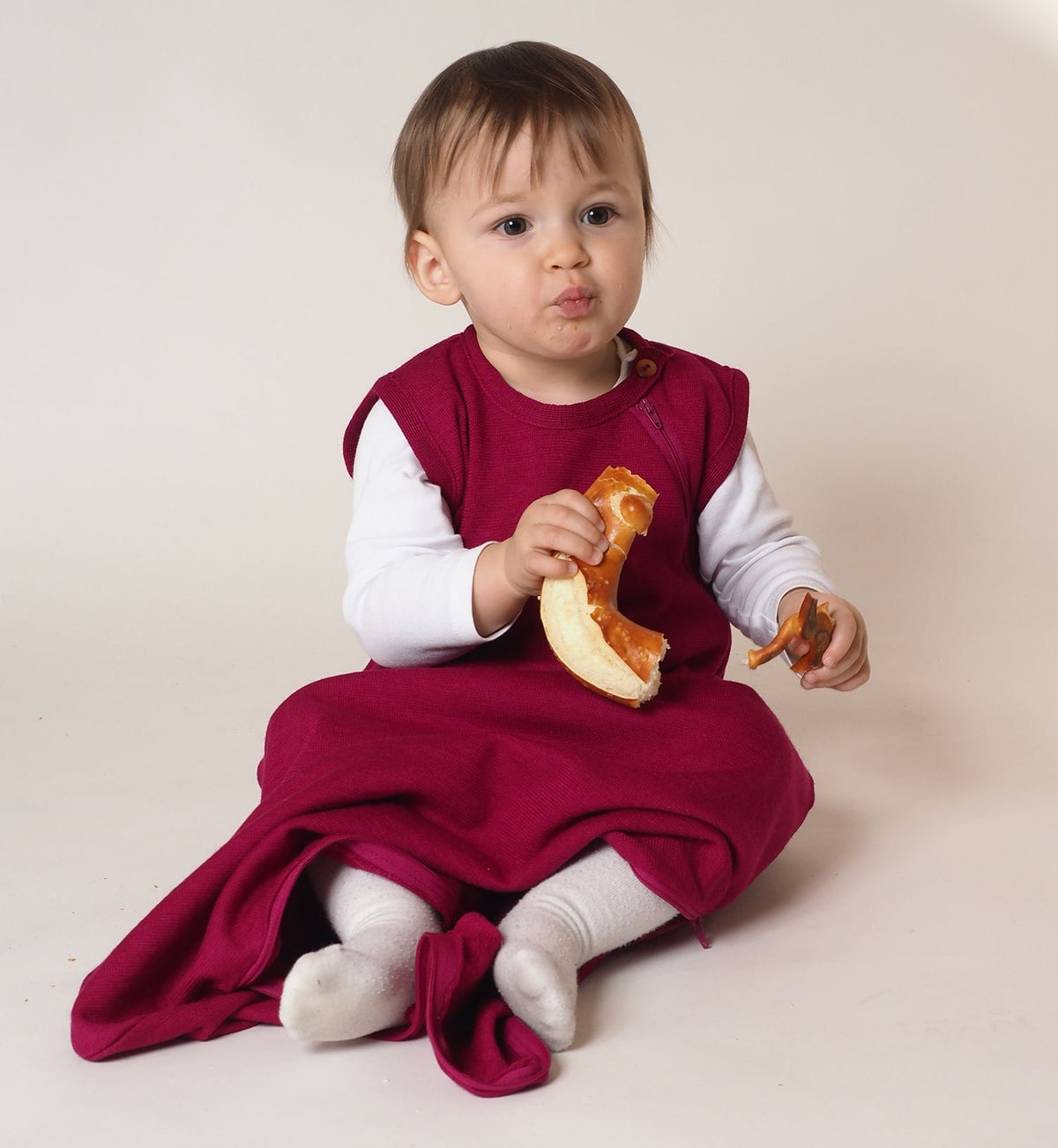 Lifestyle photo of child wearing Reiff wool/silk sleepsack in berry