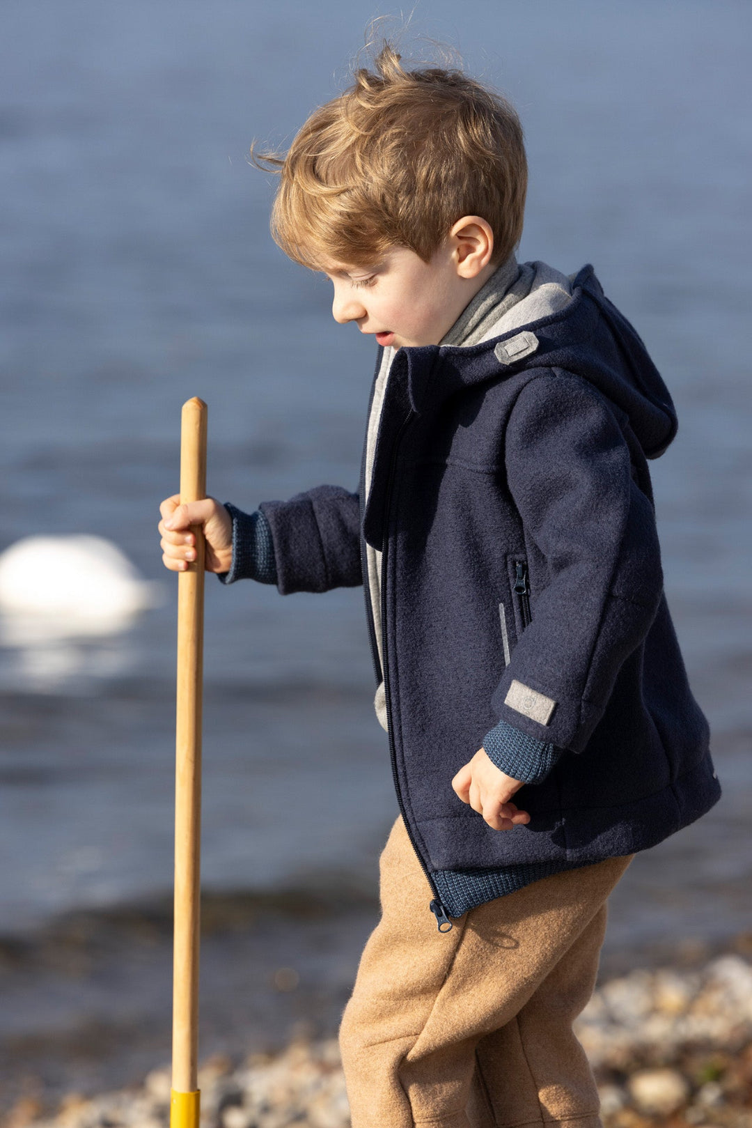 Child wearing the Disana boiled wool Outdoor Jacket in navy