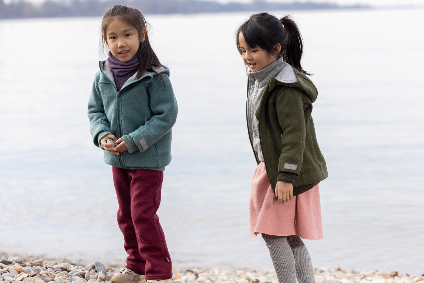 Two girls in the Disana boiled wool Outdoor Jacket in navy