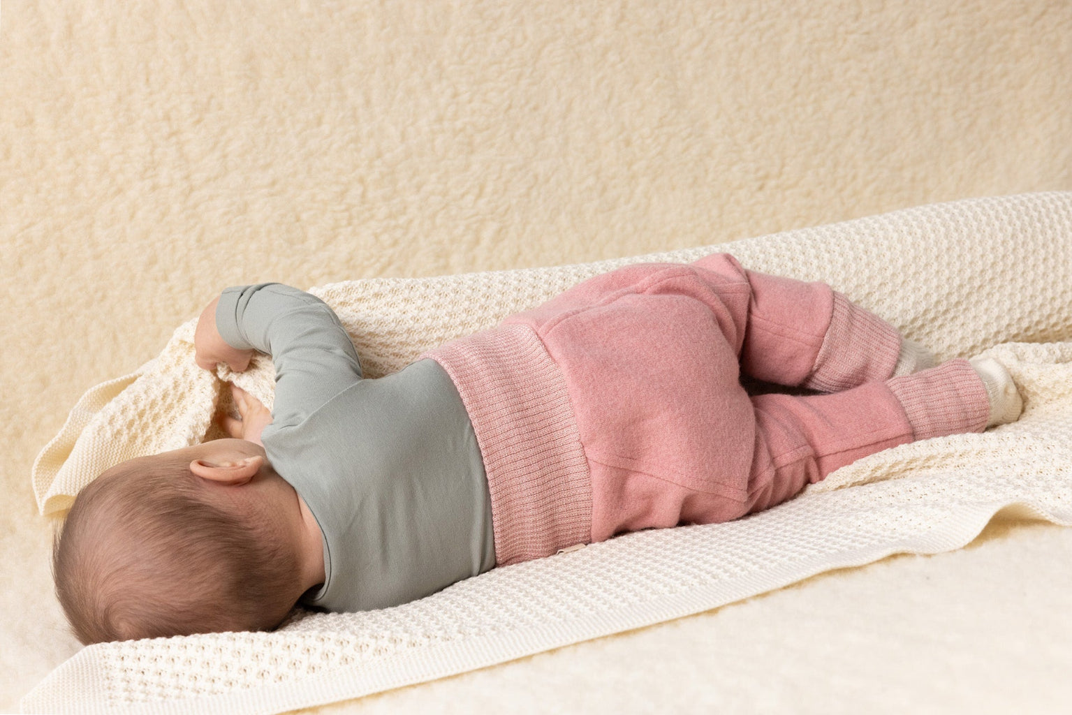 baby in Disana boiled wool bloomers in soft pink