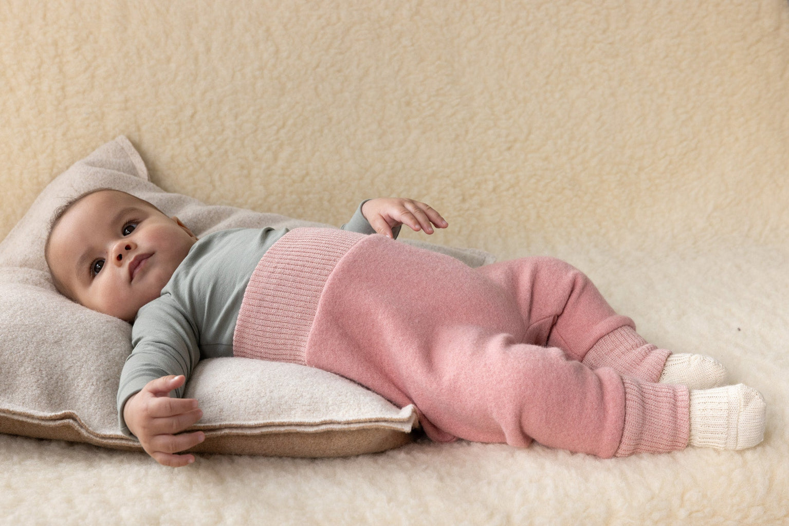 baby in Disana boiled wool bloomers in soft pink