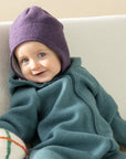 Baby in Disana boiled wool hat in aubergine