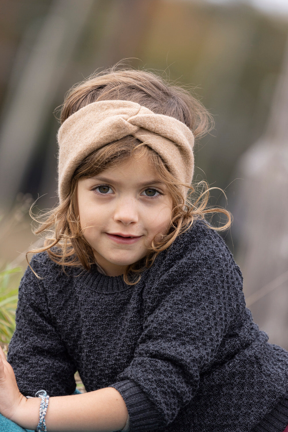 Lifestyle shot of girls wearing Disana Aran wool sweater in charcoal