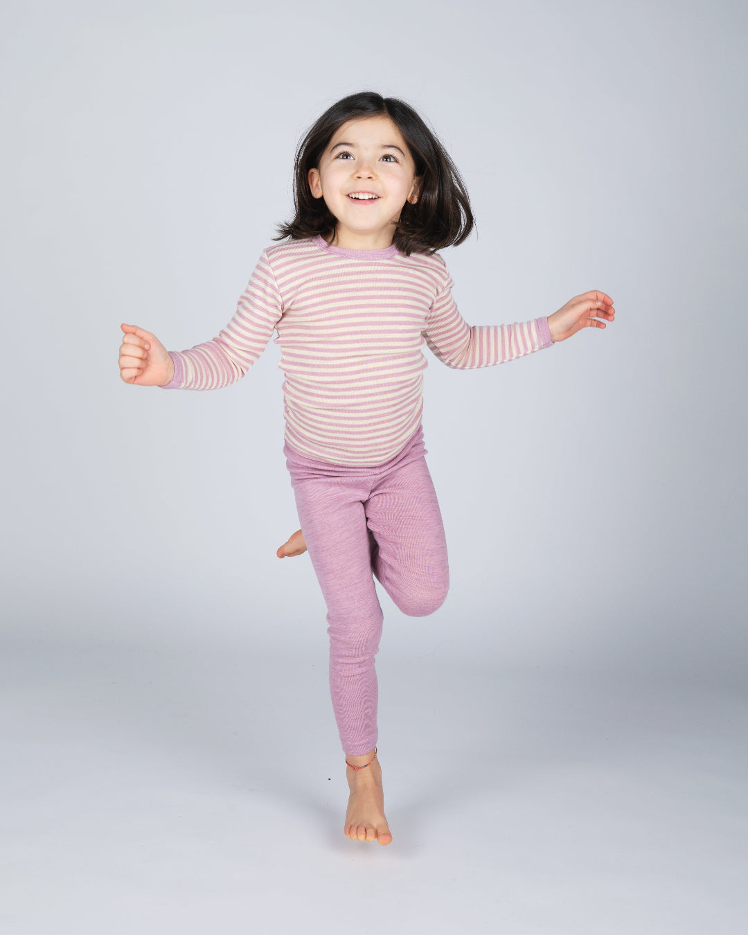 Girl in Engel children&#39;s 100% organic wool leggings in rose heather