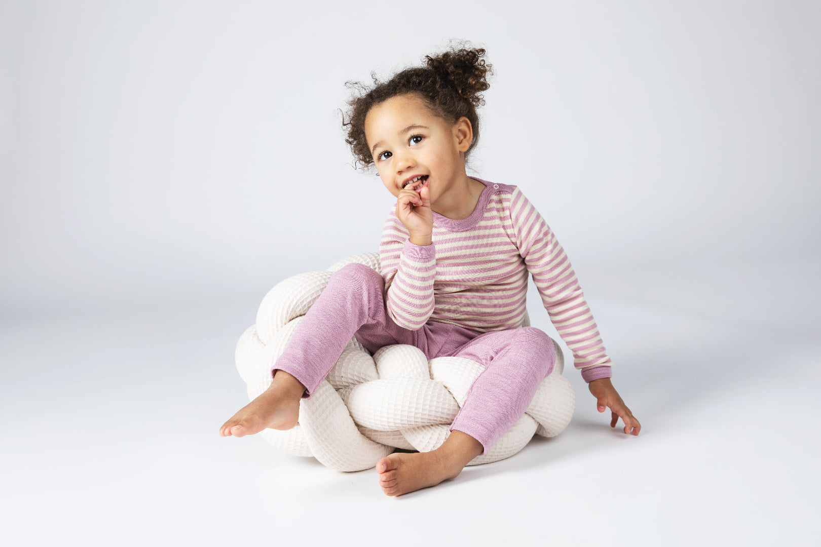 Lifestyle photo of Engel 100% wool bodysuit in rose heather