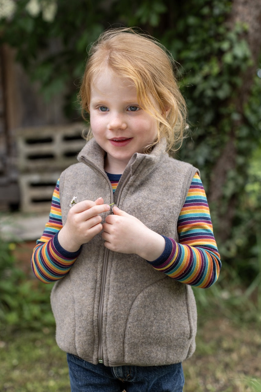 Girl in Engel kids' organic wool fleece vest in walnut
