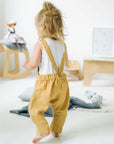 Toddler in yellow linen romper by Bigelow Lane  