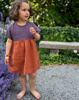 Girl in Bigelow Lane linen summer dress, in two-tone purple and clay