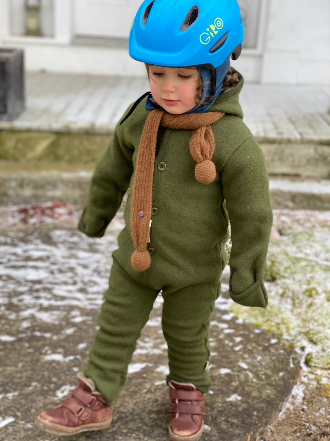 Lifestyle shot of a boiled wool overall in olive