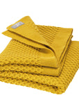 Disana's honeycomb blanket in curry. Made of 100% soft merino wool.