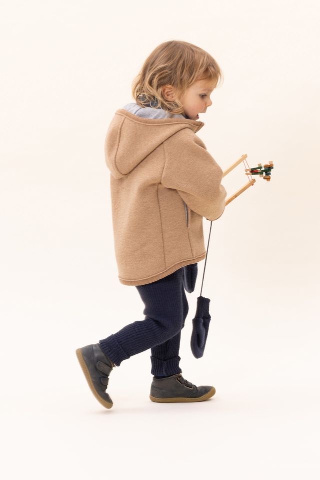 Lifestyle photo of girl in Disana boiled organic merino wool mittens in indigo