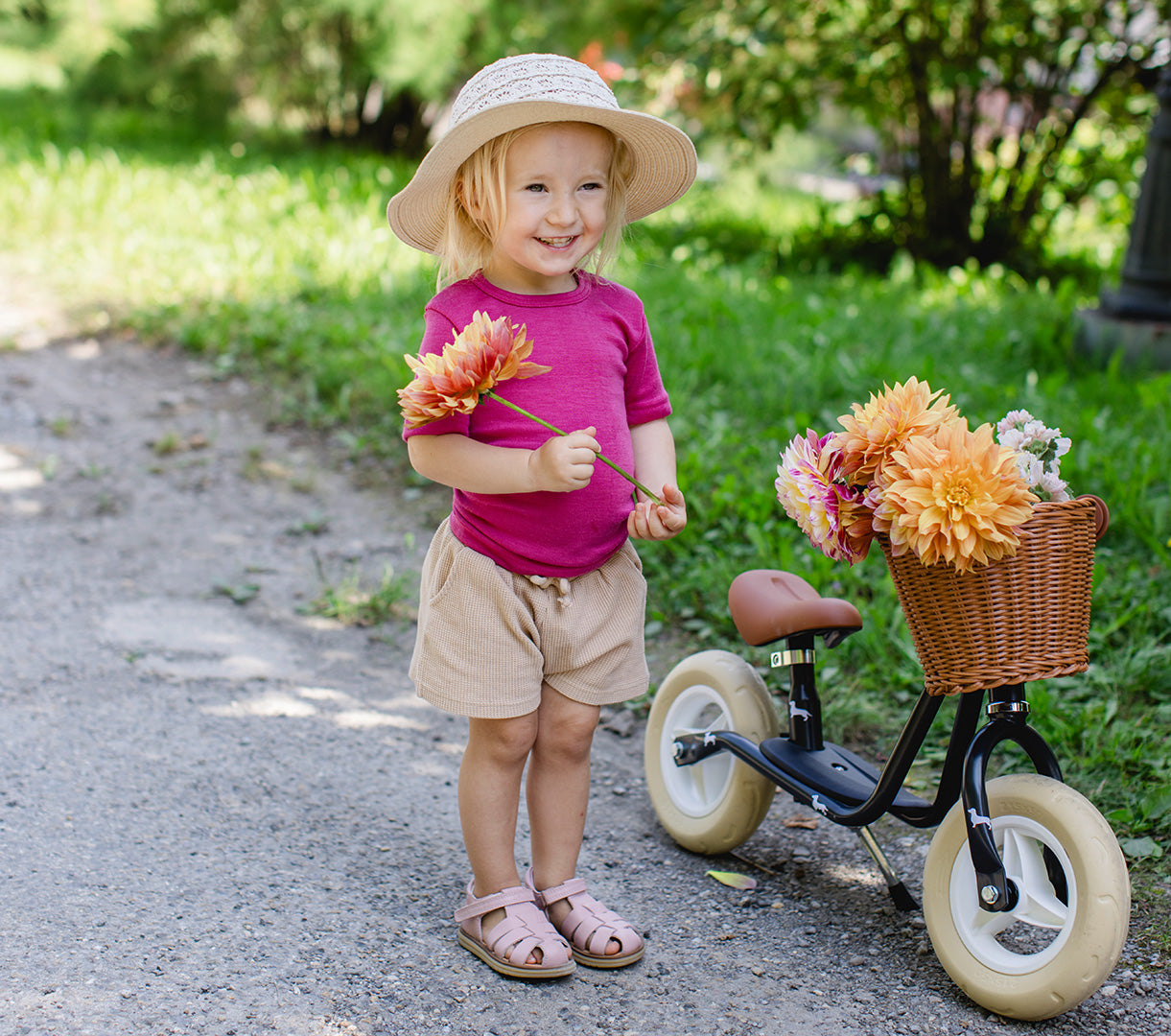 Lifestyle photo of toddler in Engel wool-silk tee in raspberry