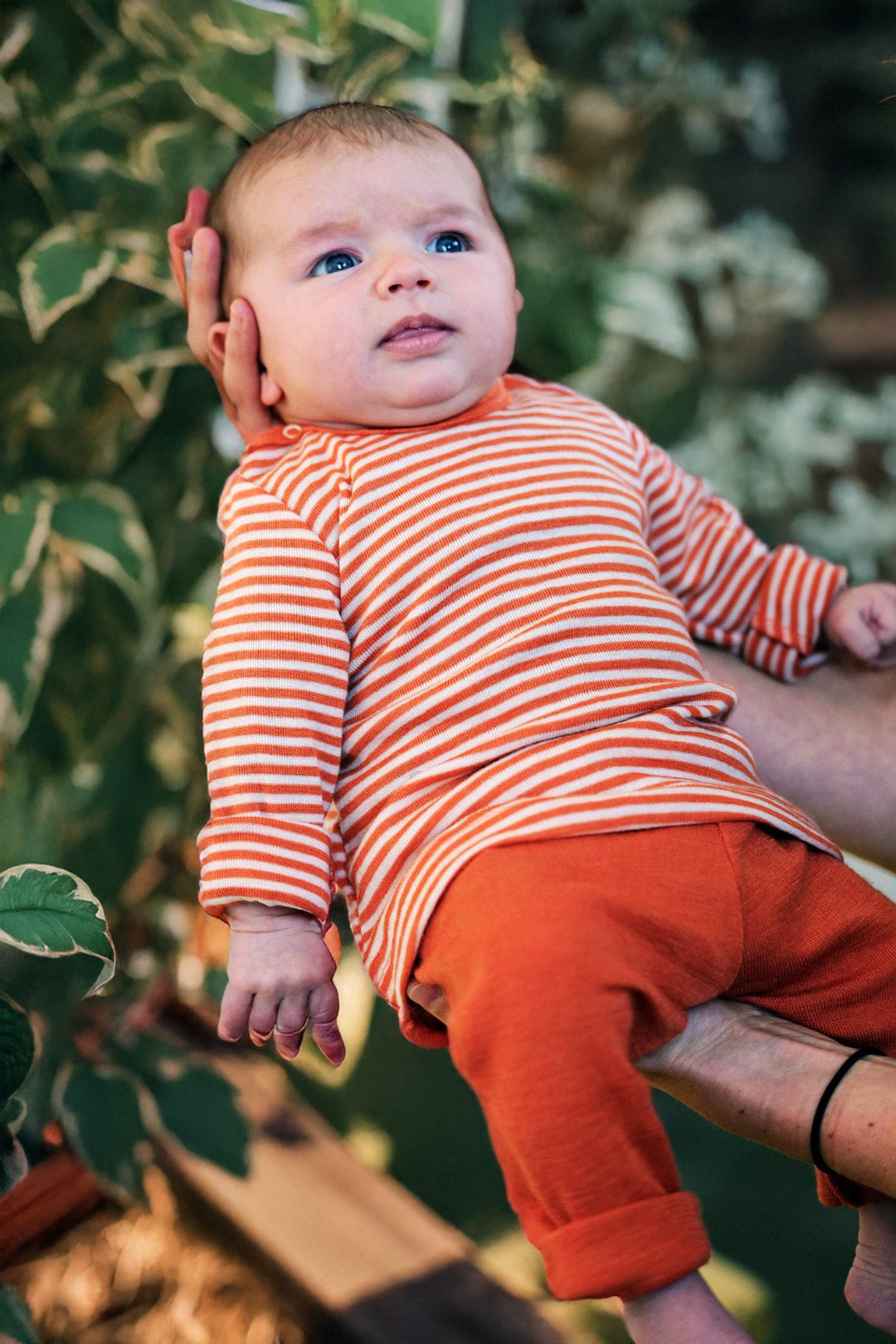 Lifestyle photo of Engel baby stripe wool/silk shirt in tangerine 