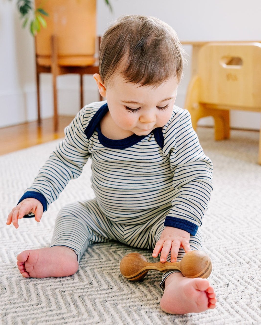 Lifestyle photo of Engel wool-silk bodysuit in navy-natural stripe.