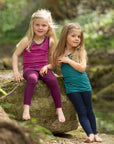 Two girls wearing Engel striped tanks in raspberry-orchid and navy-teal