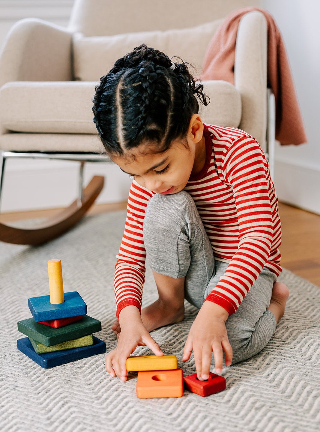 child playing in red-natural striped wool shirt by Engel