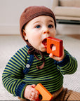 Baby in Engel wool fleece bonnet in cinnamon melange