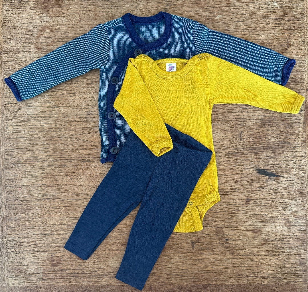 Disana blue side button melange sweater with navy wool/silk leggings and saffron wool silk bodysuit by Engel 